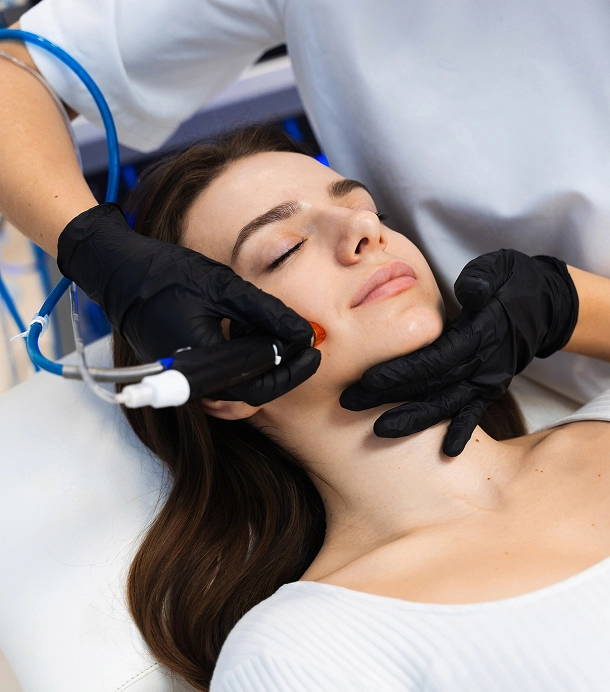 woman getting facial done by licensed specialist